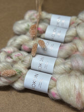 Yarn skeins with KOKON labels on a brown background