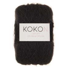 A skein of KOKON Kidsilk Mohair yarn in black color, with label showing the brand and fiber content.