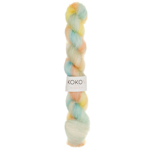 A skein of KOKON BRIGHTS Kidsilk Mohair yarn in color peach.